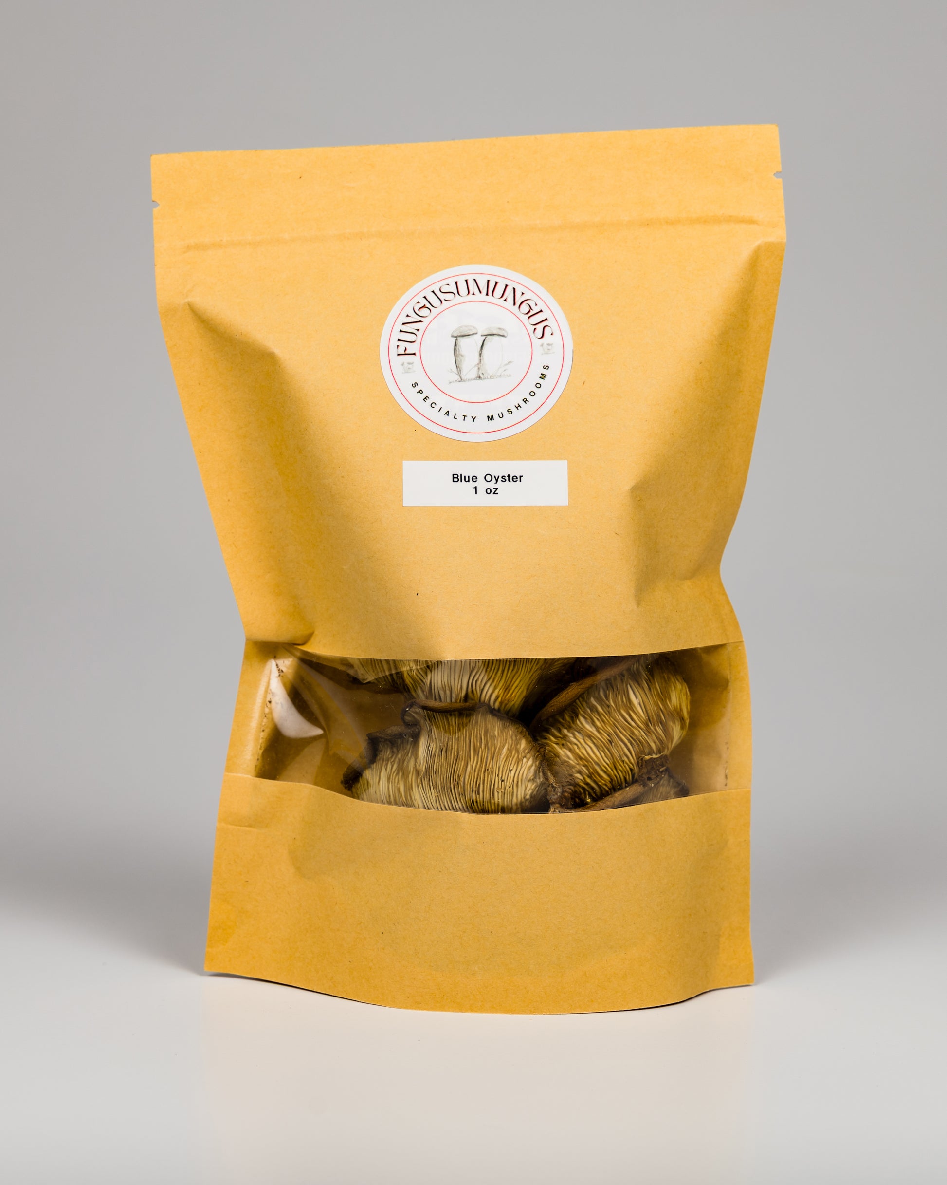 A package of dried Blue Oyster mushrooms in a clear windowed bag with a beige exterior.