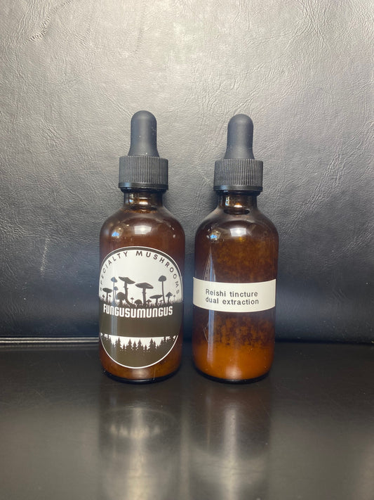 Two bottles of Reishi dual extracted tincture with dropper caps, displayed against a dark background.